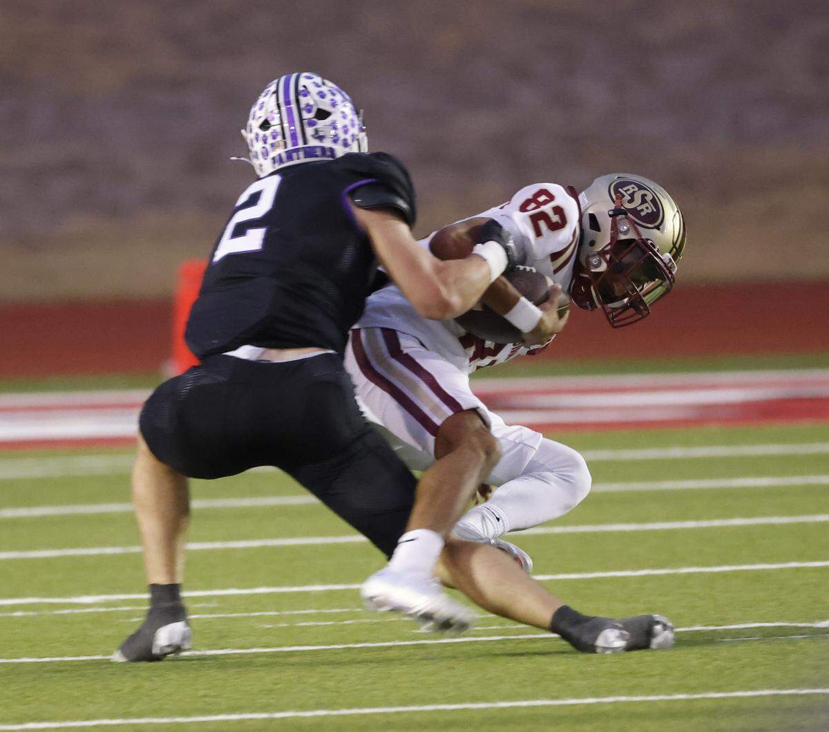 Saginaw kicker Lucas Wallis (22) is dropped by Paschal running back Truman Shelton (2) after a botched punt attempt during the first half of a UIL football game between Saginaw and Paschal at Farrington Field in Fort Worth, Texas, Thursday, October, 16, 2025.