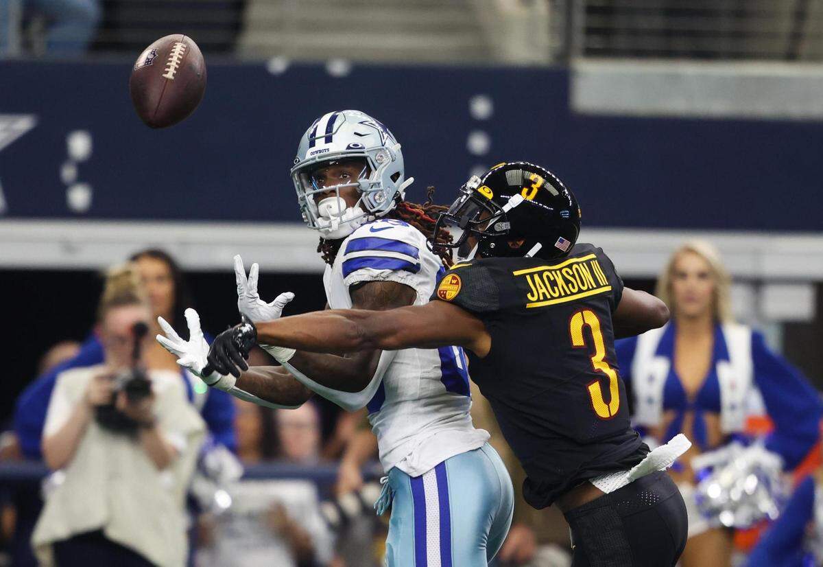 Dallas Cowboys CeeDee Lamb fights with Washington Commanders William Jackson III for the pass Sunday, Oct. 2, 2022, at AT&T Stadium in Arlington.