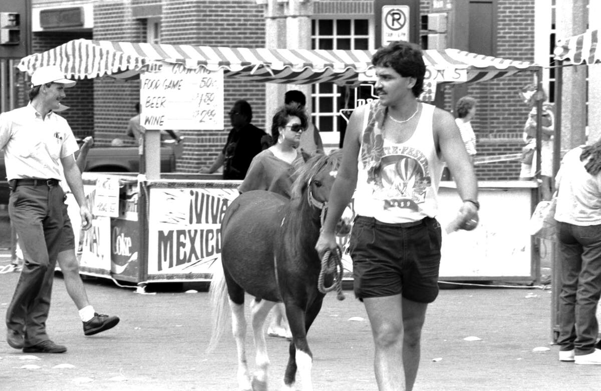Sept. 13, 1990: John Biers walks Scout the pony down Main Street during the Fiesta-In-The-Park to benefit the Mexican American College fund.