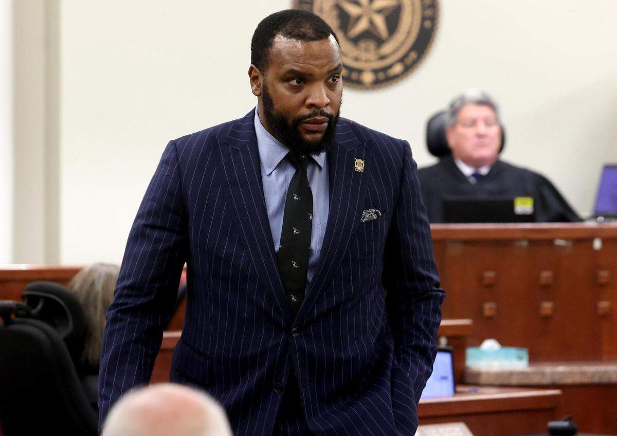 Attorney Lee Merritt leaves the courtroom after being called in by 396th District Court Judge George Gallagher on Monday. Gallagher told Merritt, who represents Atatiana Jefferson’s family in civil lawsuits, not to watch the trial because he is on the witness list. Court officials said Merritt had been watching the trial from an adjoining courtroom where there is a video feed.