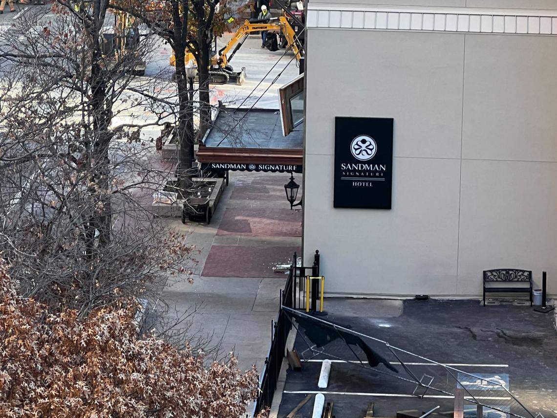 Progress was being made Tuesday, Jan. 9, 2024, toward cleaning up debris outside the Sandman Signature Hotel following an explosion Monday. Crews were digging up part of the street as an investigation continued into the cause, believed to be linked to a gas leak.