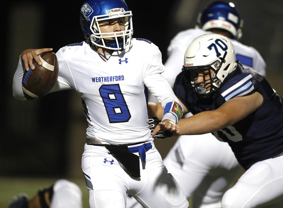 Weatherford quarterback Ken Seals (8) is pressured by L.D. Bell defensive lineman Mark Hernandez (70) during the first half of a high school football game at Pennington Field in Euless, Texas, Friday, Nov. 09, 2018. The Weatherford Roos led the Raiders 14-9 at the half. (Special to the Star-Telegram Bob Booth)