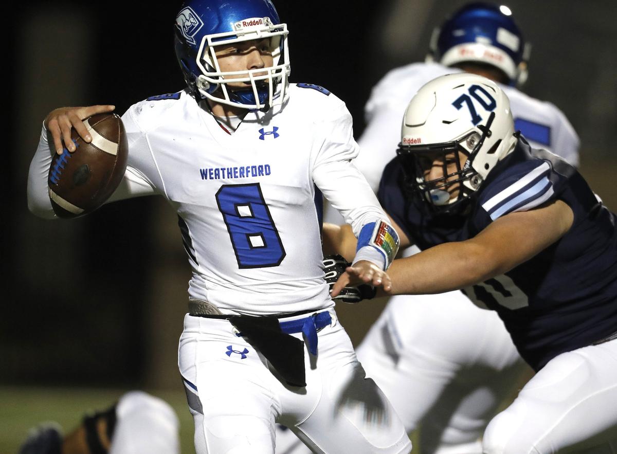 Weatherford quarterback Ken Seals is pressured by L.D. Bell defensive lineman Mark Hernandez on Nov. 9, 2018, at Pennington Field in Bedford.