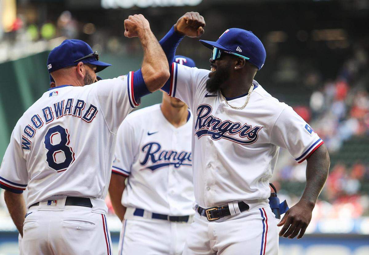 Texas Rangers manager Chris Woodward, left, and outfielder Adolis García get pumped up before the start of the home opener against the Colorado Rockies on Monday, April 11, 2022, at Globe Life Field.