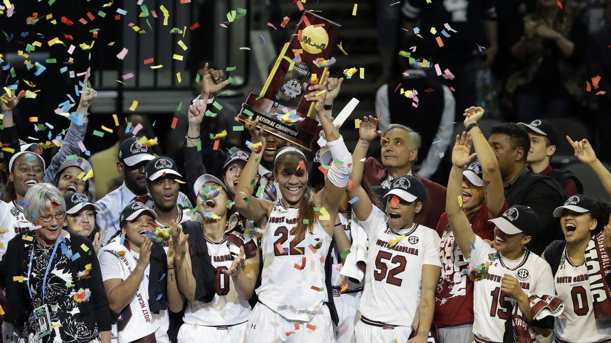 FILE - In this April 2, 2017, file photo, South Carolina forward A’ja Wilson (22) holds up the trophy as she celebrates with teammates after their win over Mississippi State in the final of the NCAA women’s Final Four college basketball tournament, in Dallas.