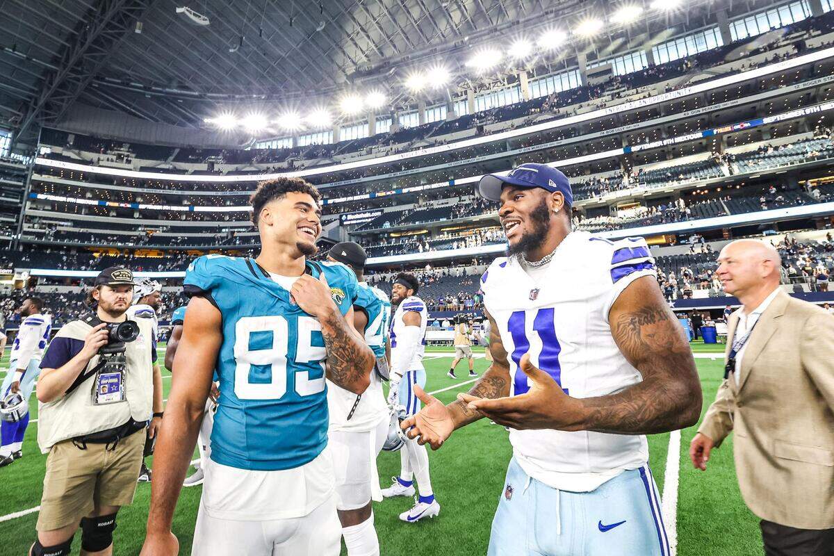Jacksonville Jaguars tight end Brenton Strange (85) speaks with Dallas Cowboys pass rusher Micah Parsons (11) after the first preseason game between the Dallas Cowboys and Jacksonville Jaguars at AT&T Stadium in Arlington, Texas on Saturday, Aug. 12, 2023.