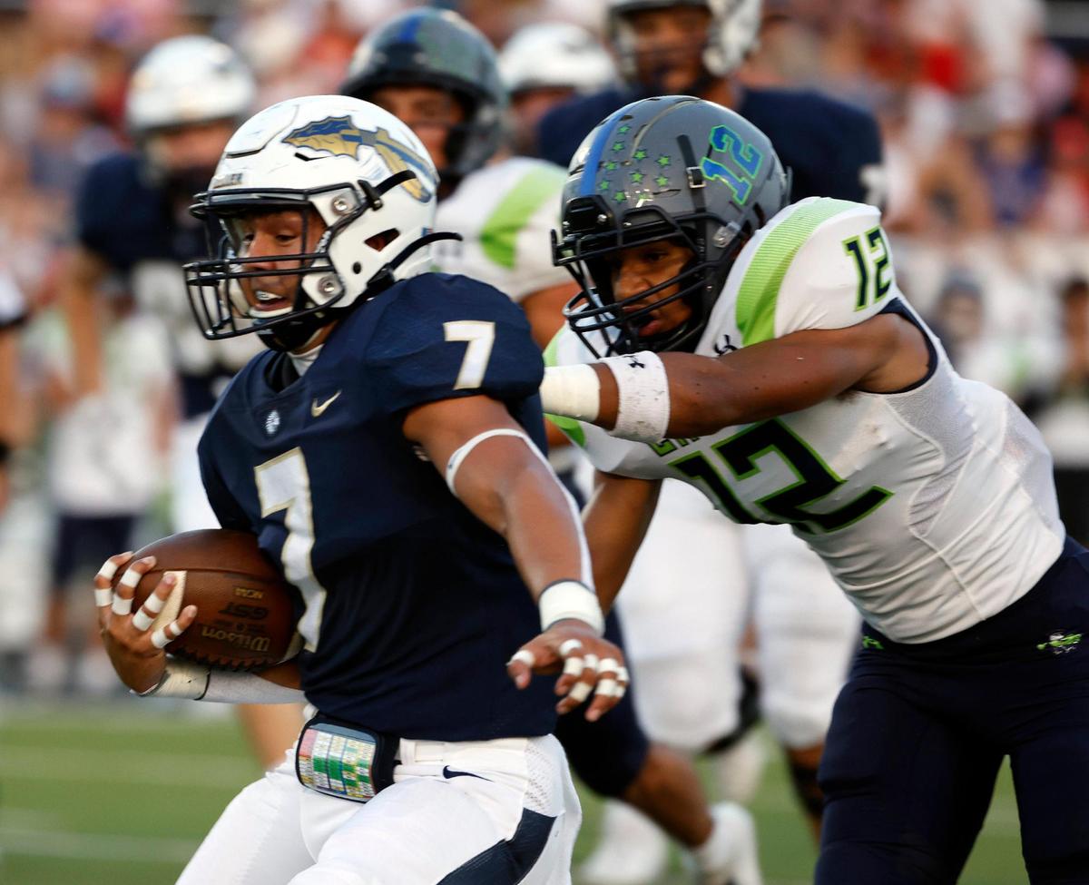 Eaton safety Jordan Park (12) grabs Keller running back Ryan Ventura (7) from behind in the first half of a UIL high school football game at Keller ISD Stadium in Keller, Texas, Friday, Sept. 15, 2023. Keller led Eaton 31-14 at the half.