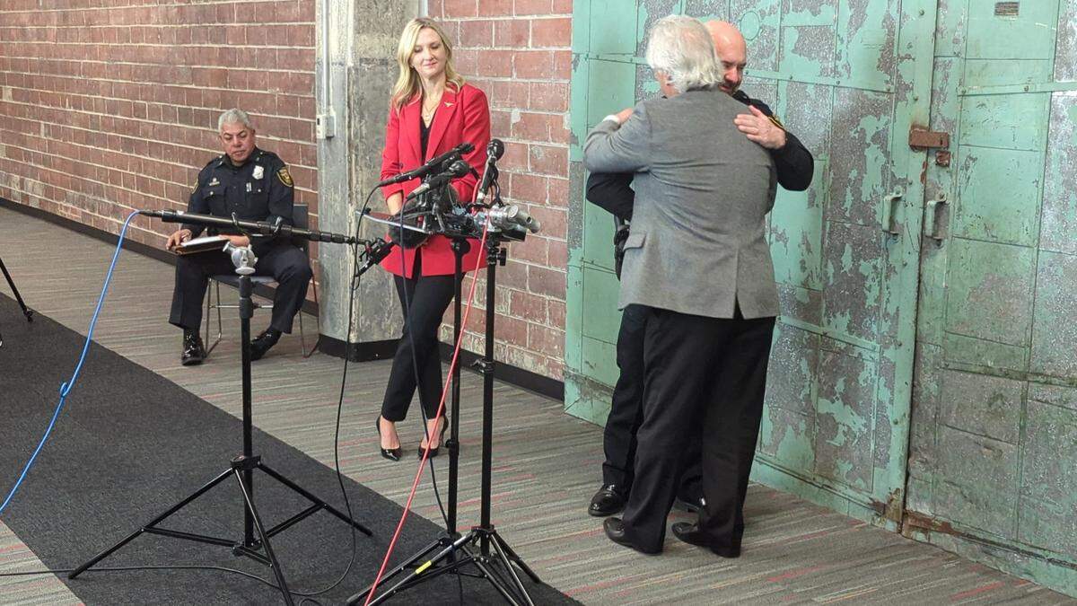 Fort Worth City Manager David Cooke hugs Police Chief Neil Noakes as Noakes announces his May 2025 retirement plans on Monday, Dec. 9, 2024.