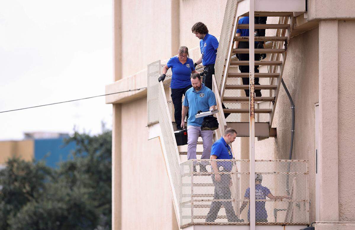 Law enforcement investigate the scene where a shooting at an Immigration and Customs Enforcement facility occurred in Dallas on Wednesday, Sept. 24, 2025.