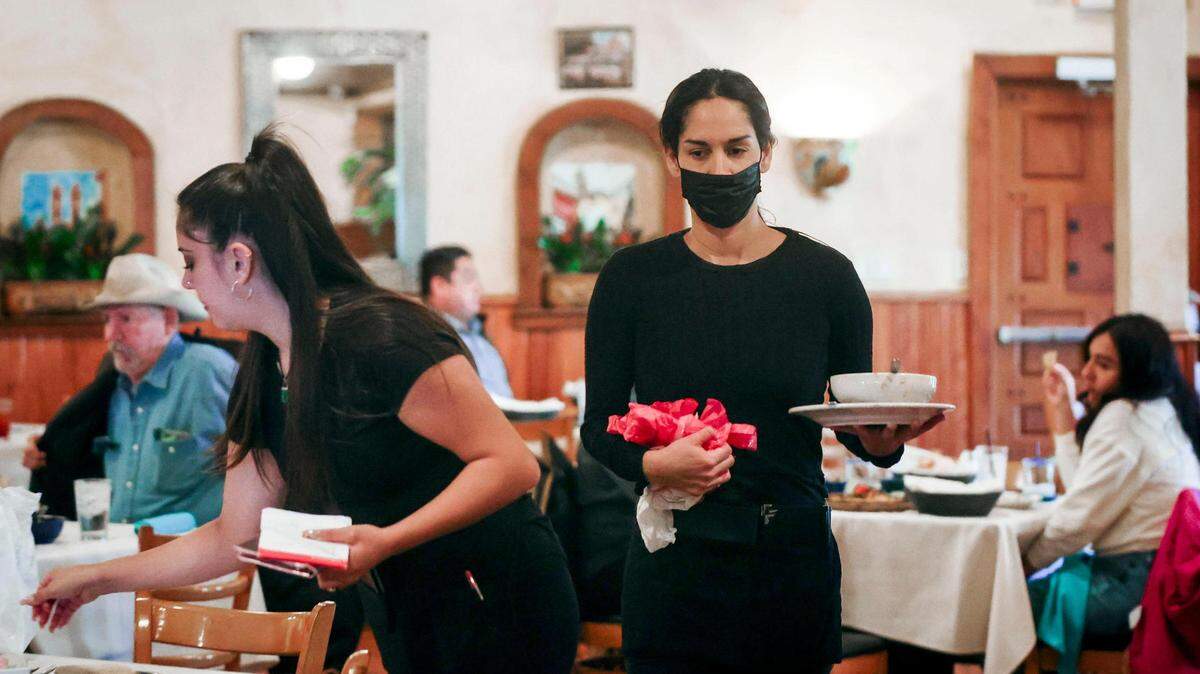 Graciela Ruvalcaba, left, and Iris Gonzalez wait on tables Friday at Joe T. Garcia’s in Fort Worth.
