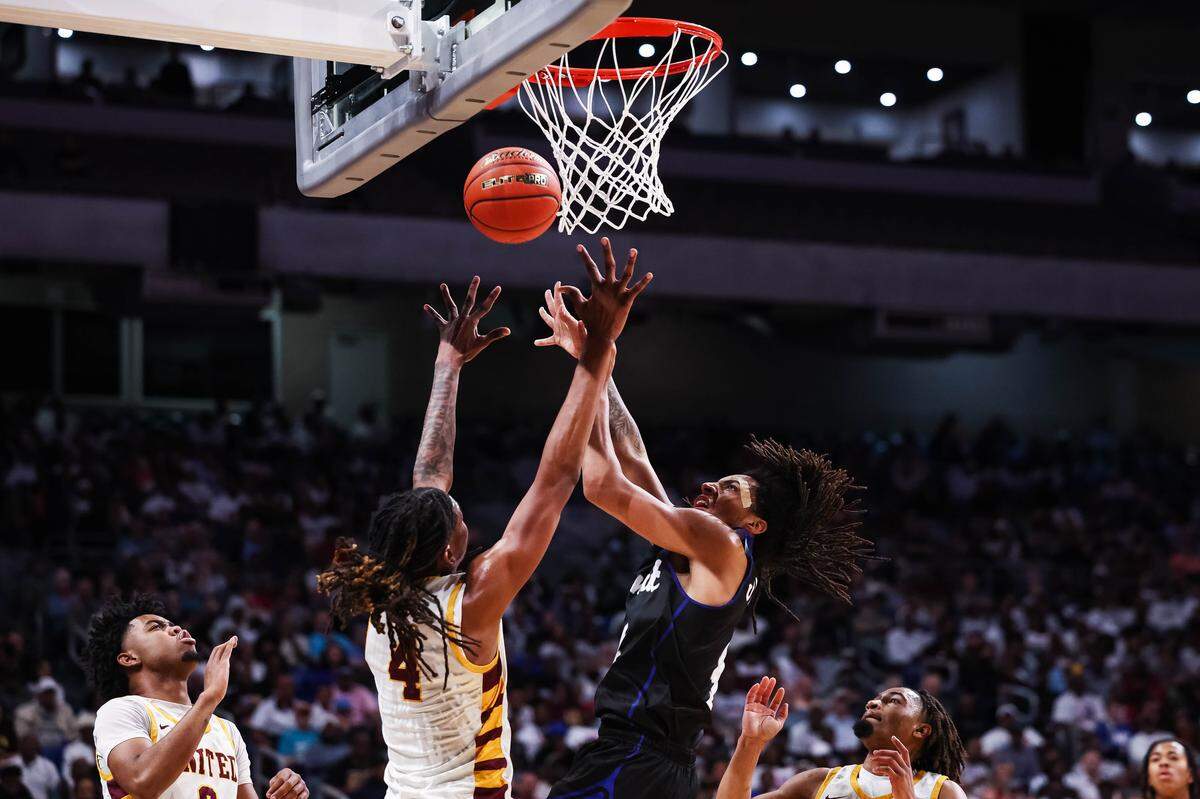 Mansfield Summit guard Jaxon Sneed (4) goes up for the ball on a rebound over a outreached Beaumont United defender in the Class 5A Division II state championship at The Alamodome in San Antonio, Texas, March 14, 2026.