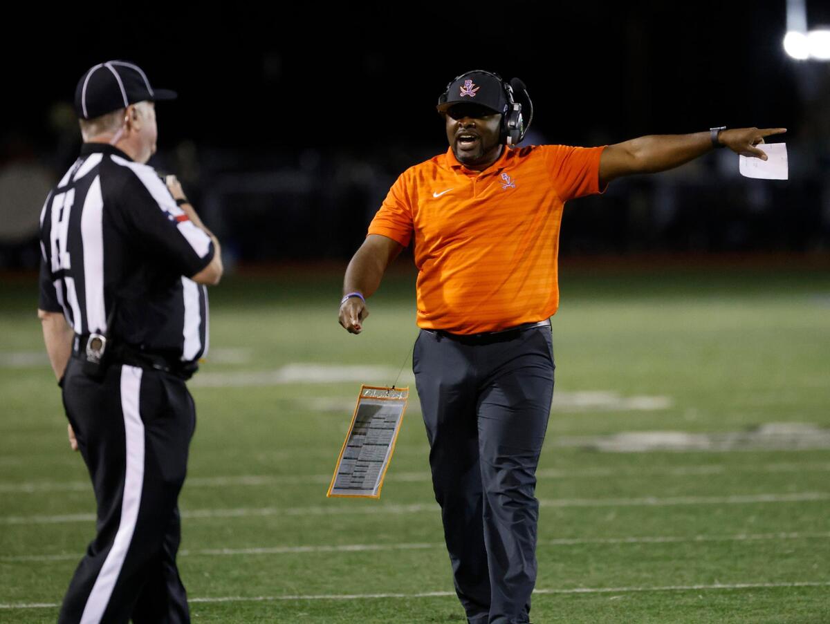 Bowie head coach Joseph Sam points out something to the head linesman during a District 8-6A football game at C.H. Wilemon Field in Arlington, Texas, Friday, Oct. 18, 2024.