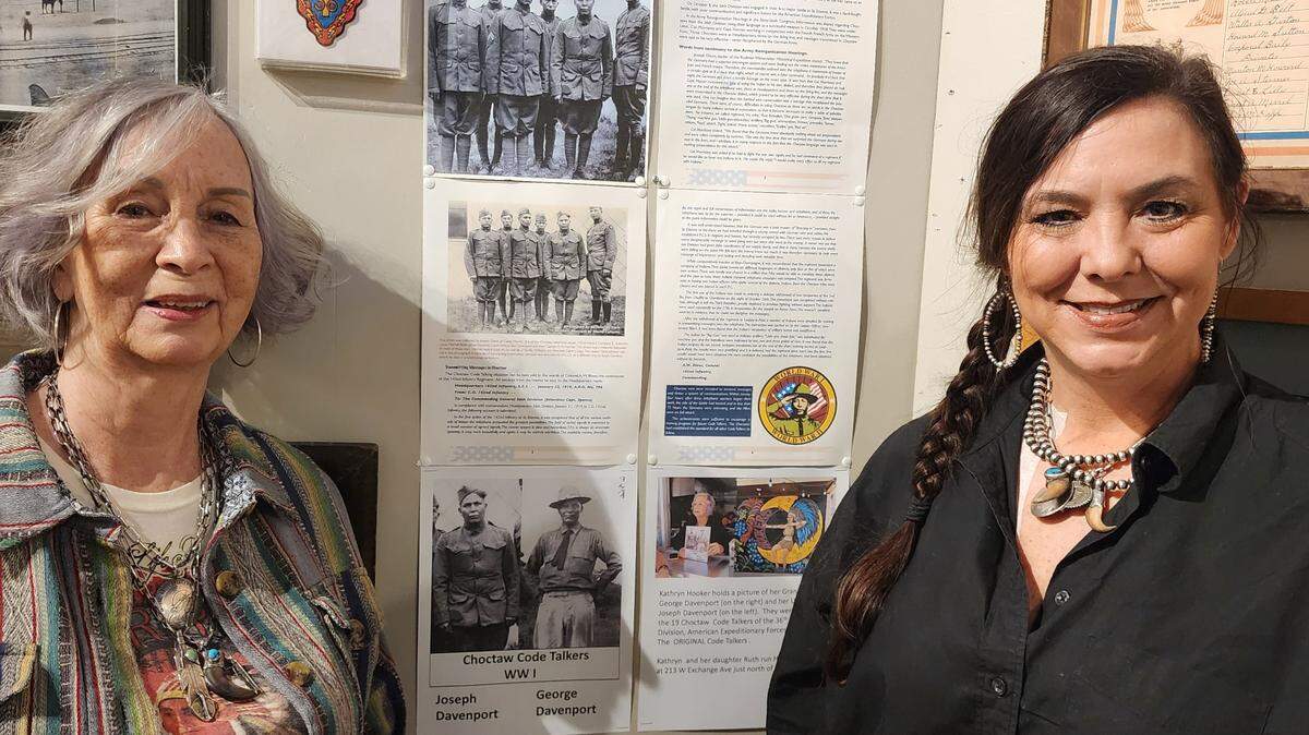 Kathryn Hooker (left) and her daughter, Ruth Hooker, next to the display honoring the original Choctaw code talkers in World War I. Among them were Kathryn’s grandfather (Ruth’s great grandfather) George Davenport and her uncle (Ruth’s great uncle) Joseph Davenport.