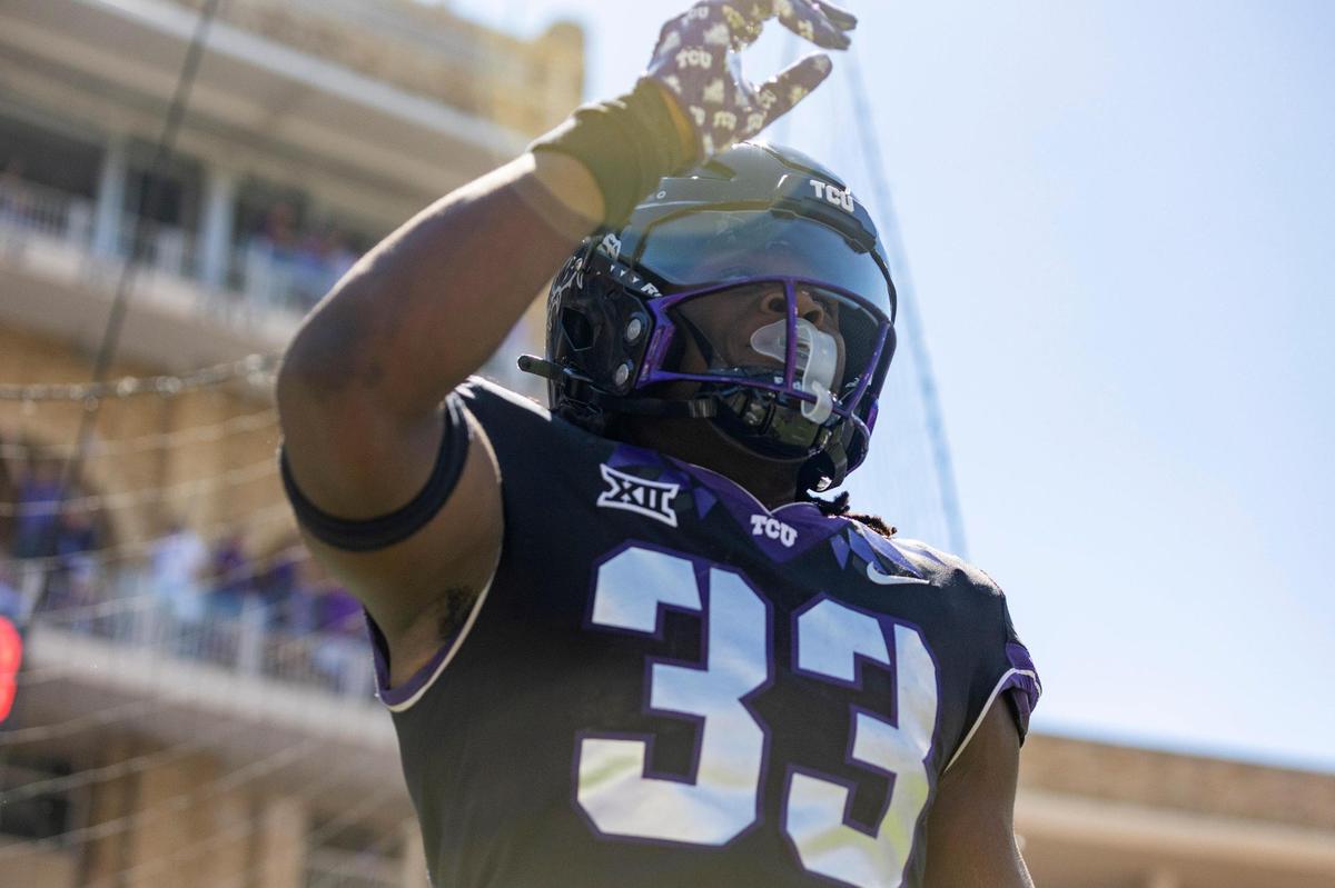 TCU running back Kendre Miller waves after scoring a touchdown during their game against OU at the Amon G. Carter Stadium in Fort Worth, Texas, on Saturday, Oct. 1, 2022.