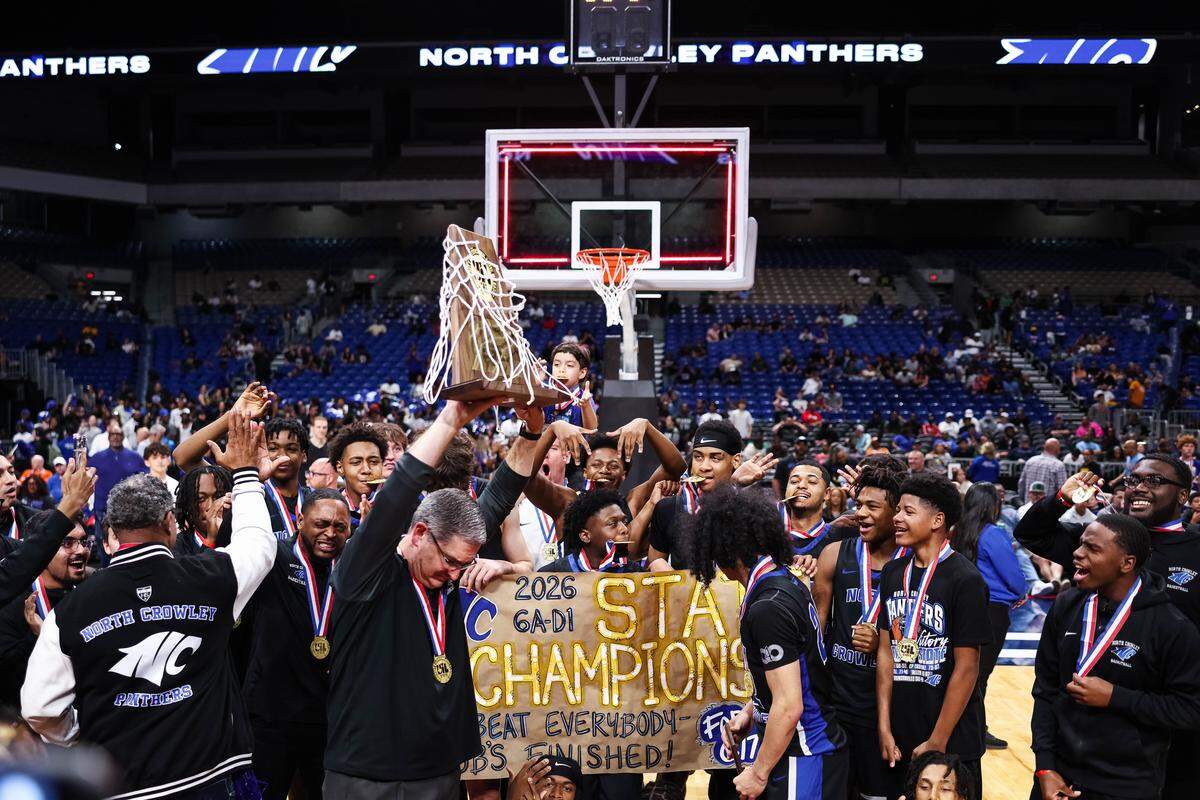 North Crowley head coach Tommy Brakel emotionally hoists the trophy after winning the Class 6A Division I state championship game against San Antonio Brennan on Saturday at the Alamodome in San Antonio.
