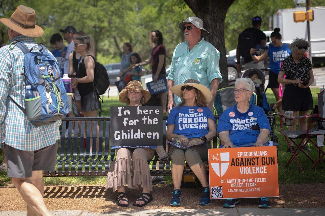 March for Our Lives attendants cool down in the shade as temperatures rise above 100 degrees during the rally on Saturday, June 11, 2022, at the Tarrant County Courhouse in Fort Worth, Texas. Advocates for gun reform gathered outside of the courthouse before marching downtown.