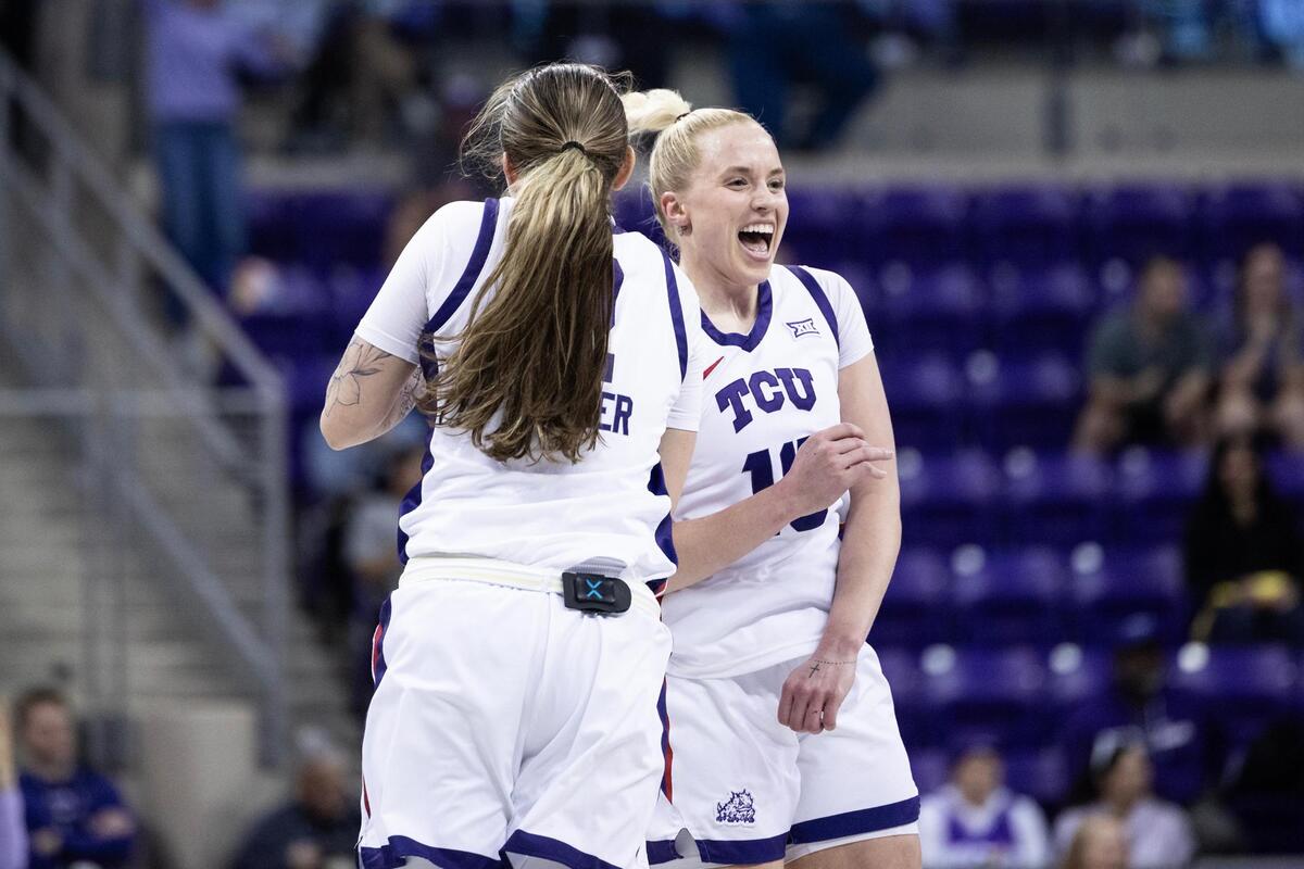 TCU guards Madison Conner (2) and Hailey Van Lith (10) celebrate after Conner made a three-point basket against Houston at Schollmaier Arena in Fort Worth on Wednesday, Feb. 26, 2025.