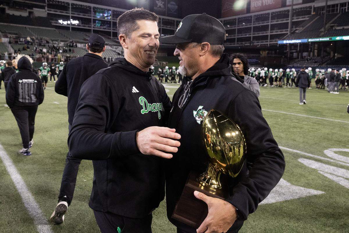 Southlake Carroll Head Coach Riley Dodge is presented with a trophy after winning the UIL Division II Regional playoff game 49-31 against Prosper at Choctaw Stadium in Arlington on Friday, Nov. 28, 2025.