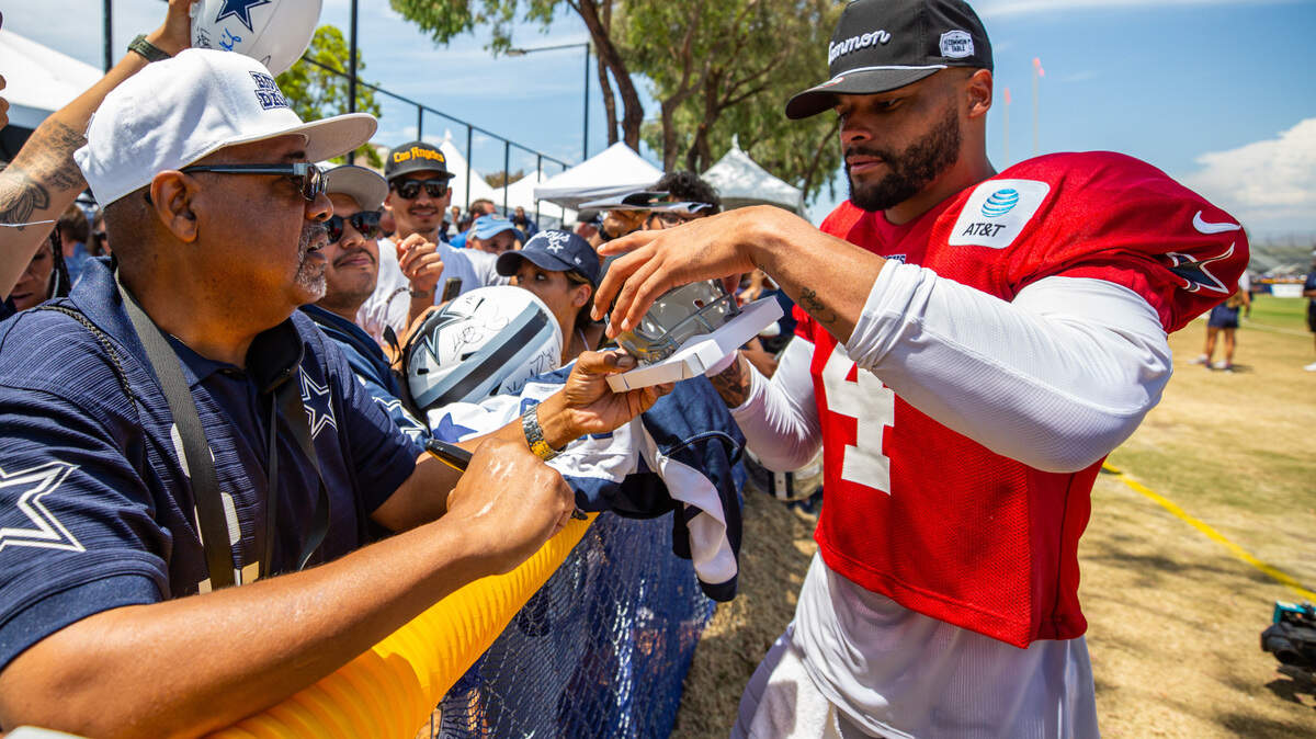 Fans who travel to Oxnard, Calif., to see the Cowboys training camp will have many opportunities to meet the players and get autographs. Quarterback Dak Prescott (4) signs autographs at River Ridge Playing Fields after a 2022 practice.