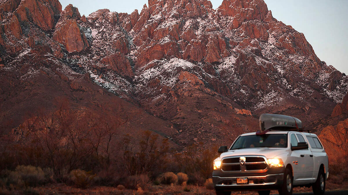 In this Thursday, March 4, 2020, photograph, a motorist carries a canoe on the roof his pickup truck while leaving the Organ Mountains Desert Peaks National Monument near Las Cruces, N.M. La Cruces cops said they rescued 24 hikers from El Paso after they were stranded and “disoriented” in the Organ Mountains and couldn’t find they way back.