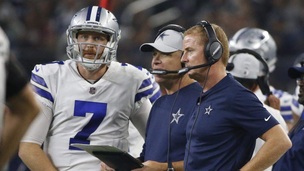 Cowboys head coach Jason Garrett, right, talks with quarterback Cooper Rush during the first half of Sunday’s game against the Arizona Cardinals at AT&T Stadium.