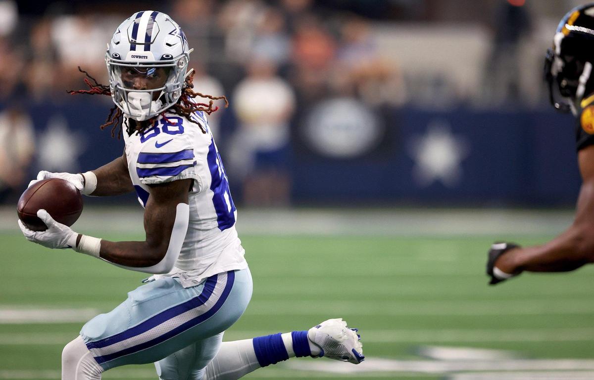 Dallas Cowboys wide receiver CeeDee Lamb runs the ball against the Washington Commanders defense on Sunday, October 2, 2022, at AT&T Stadium in Arlington.