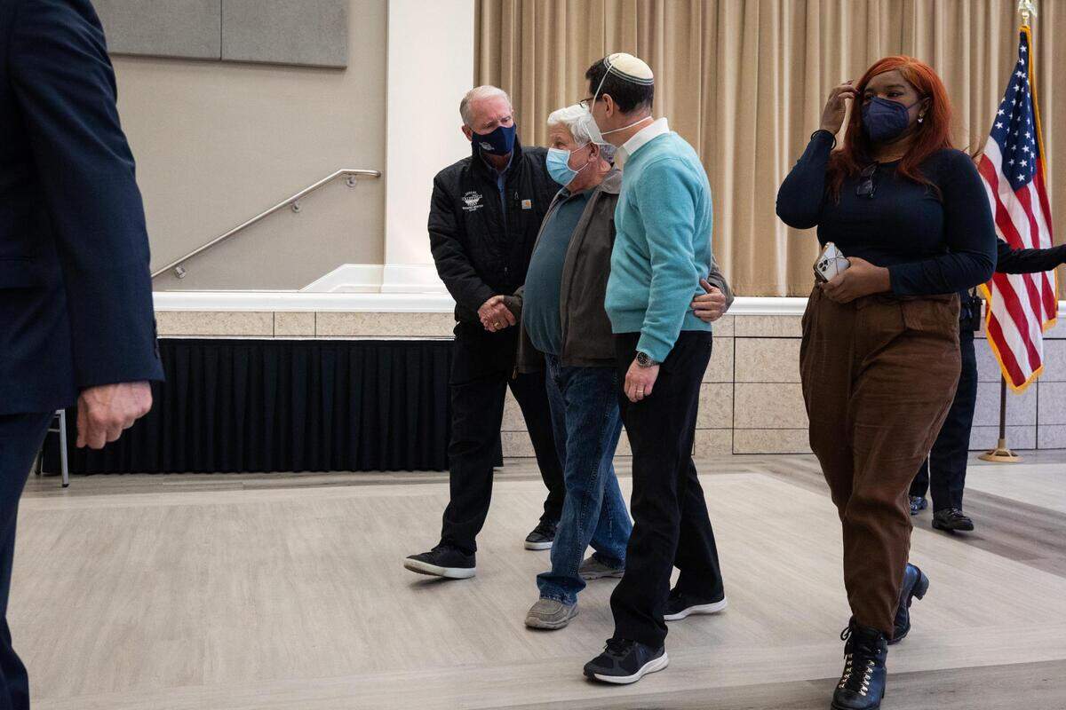 Rabbi Charlie Cytron-Walker, Congregation Beth Israel, right, walks out with others after the press conference Friday, Jan. 21, 2022, in Colleyville.