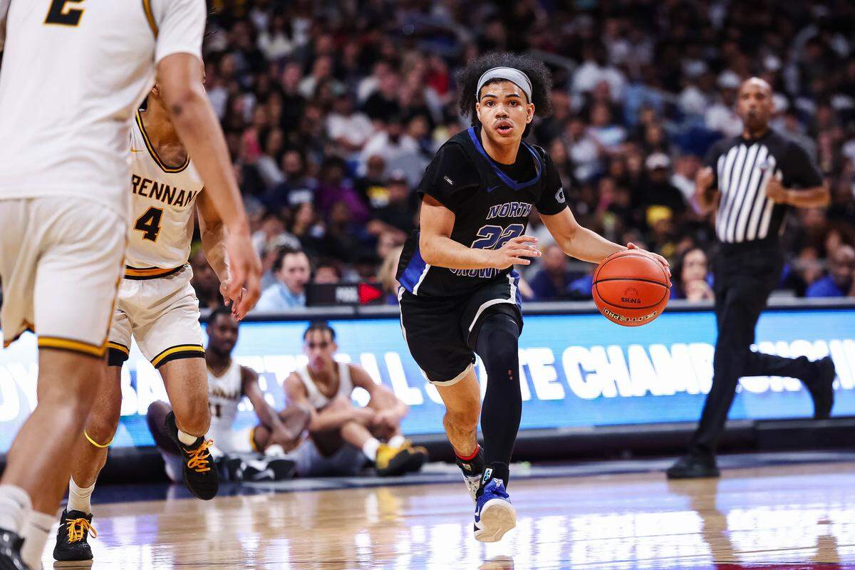 North Crowley guard Isaak Hayes (22) drives with the ball past a San Antonio Brennan defender in the Class 6A Division I state championship at The Alamodome in San Antonio, Texas, March 14, 2026.