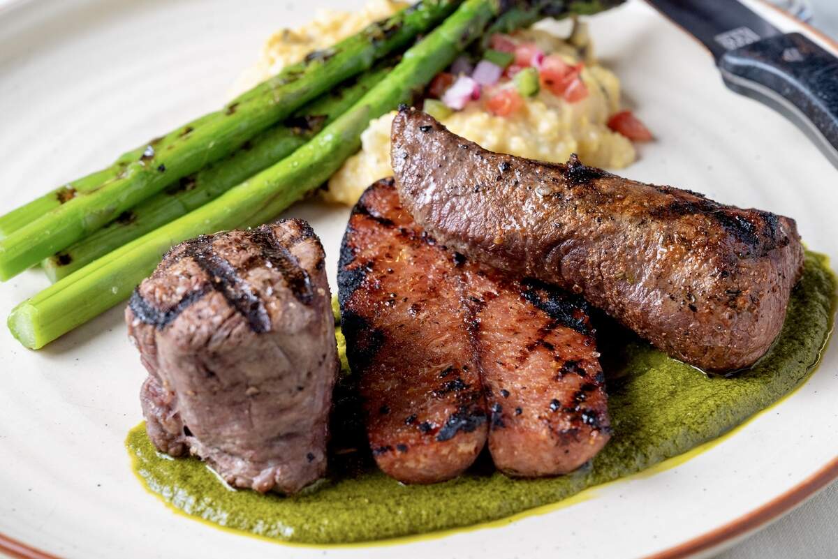 A mixed grill with a bison filet and house-made andouille sausage is one of the traditional platters at Bonnell’s Fine Texas Cuisine in Fort Worth, Texas.