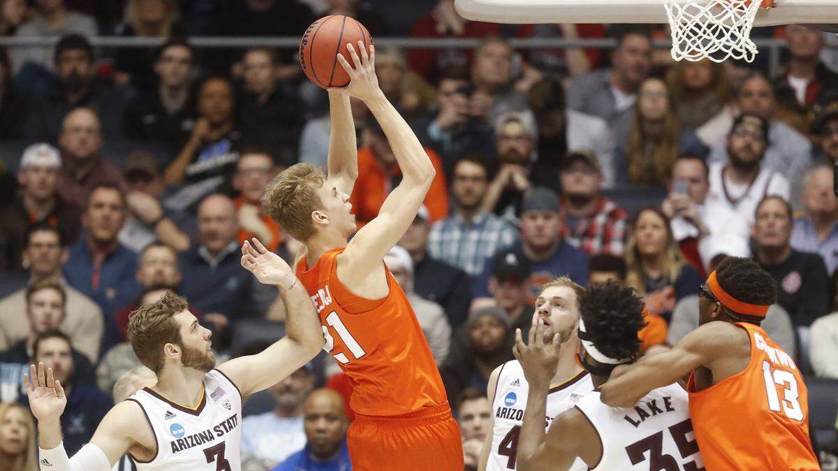 Syracuse's Marek Dolezaj shoots next to Arizona State's Mickey Mitchell, left, and other defenders during the first half in a 60-56 win Wednesday night in Dayton, Ohio.