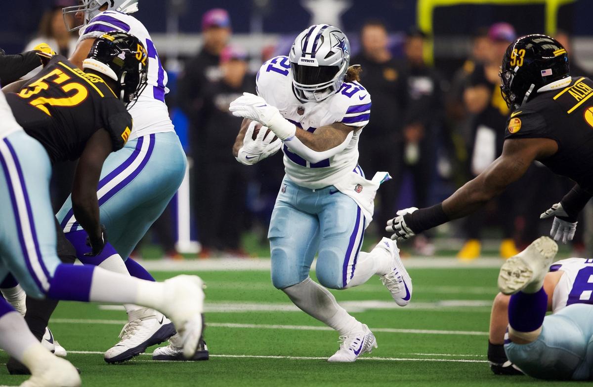 Dallas Cowboys running back Ezekiel Elliott finds a hole in the Washington Commanders defense on Sunday, October 2, 2022, at AT&T Stadium in Arlington.