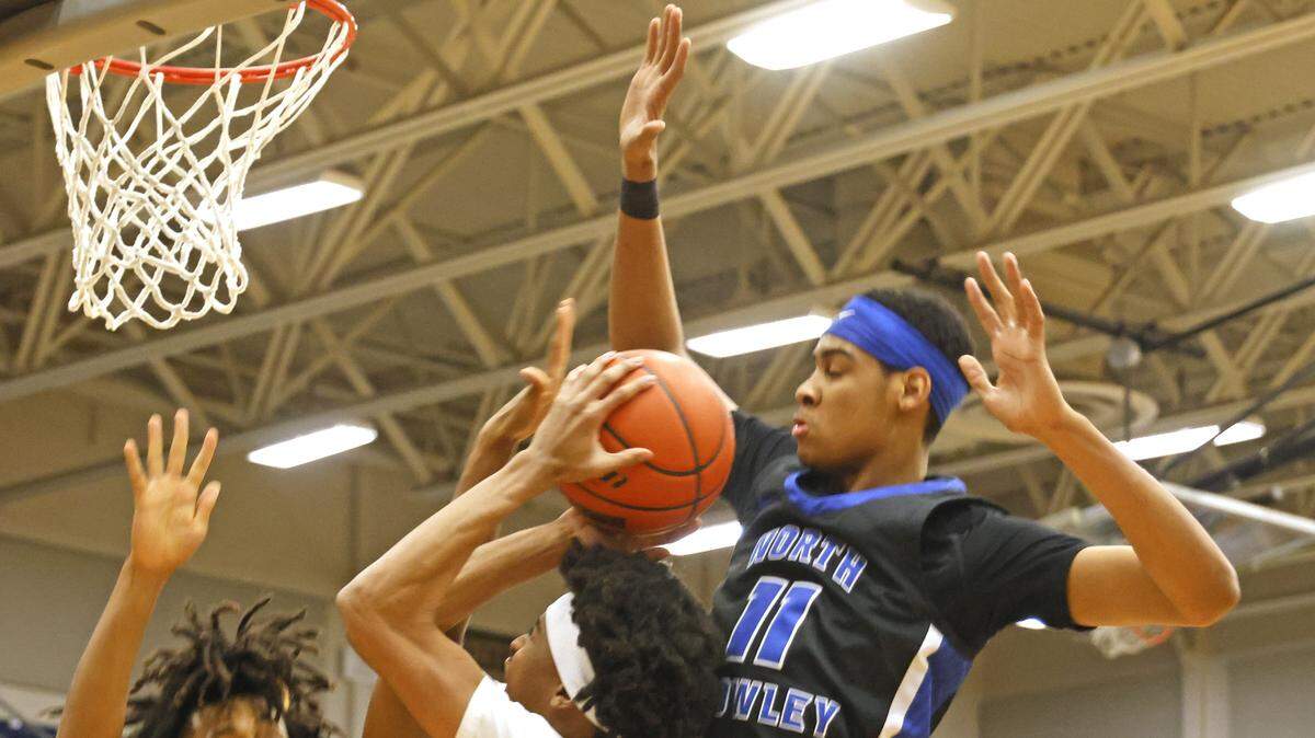 Mansfield's Chase Jackson (4) gets a bucket defended by North Crowley wings Jonathan Fox (21) and Trey Hall (11) during the first half of a UIL boys basketball game between North Crowley and Mansfield at Mansfield High School in Mansfield, Texas, Tuesday Jan. 20, 2026
