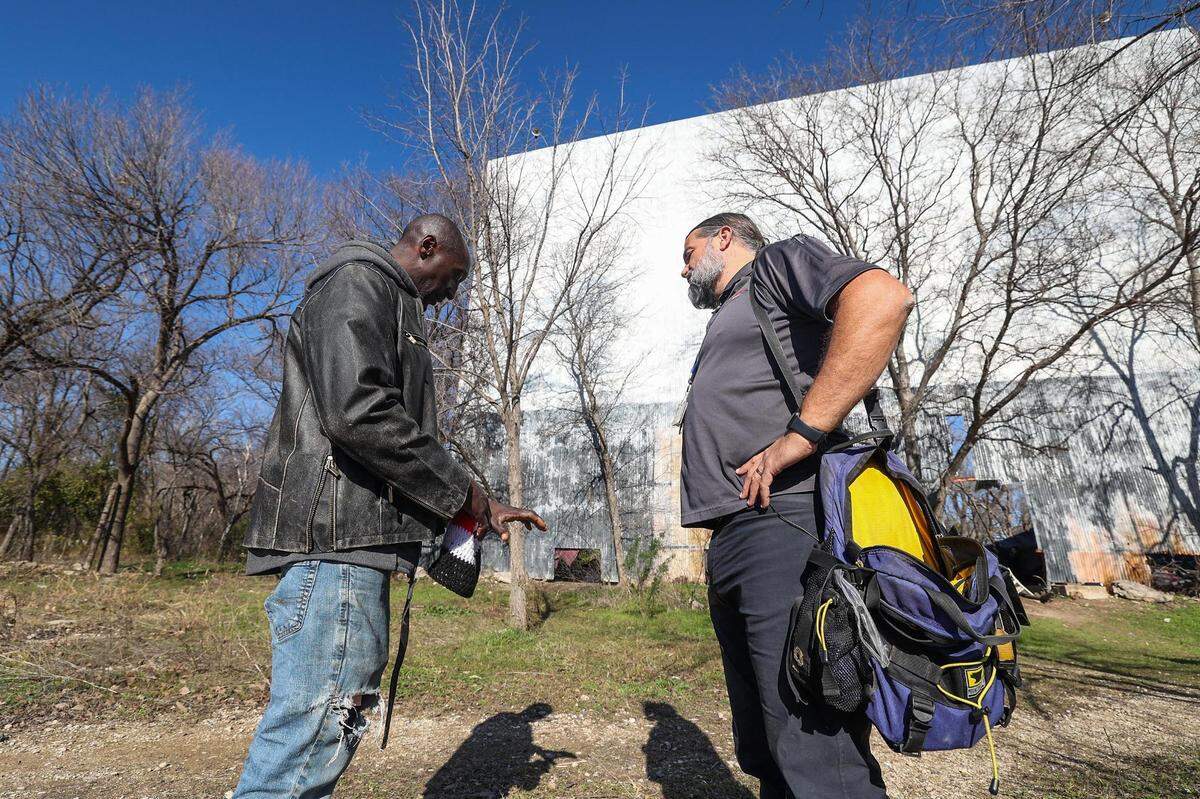 Ronald Northern explains his arthritis pain in his left hand to PA Joel Hunt during a patient visit at an old drive in movie theater in Fort Worth on Jan. 9.