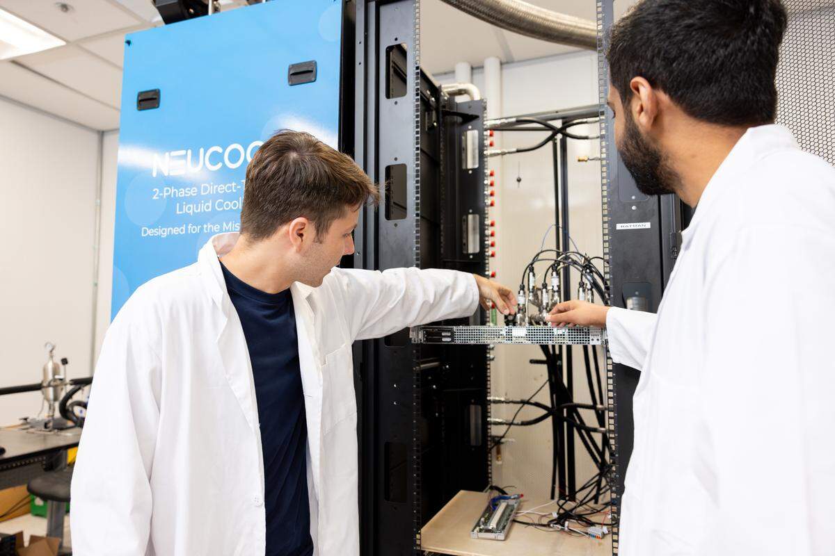 UT Arlington PhD students Braxton Smith, left, and Sai Abhideep Pundla show the components in an Accelsius cooling distribution unit in an engineering lab on campus on July 29, 2025. Smith and Pundla are leading a government-funded project to find more efficient ways to cool powerful AI computing chips.