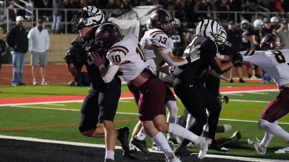 Grandview running back Elijah Dominguez (0) gets his helmet dislodged by Whitesboro’s Troy Randall (10) as he scores one of his two touchdowns for the Zebras on Thursday, November 14, 2024 at Mustang-Panther Stadium in Grapevine, Texas. Grandview defeated Whitesboro 54-17.