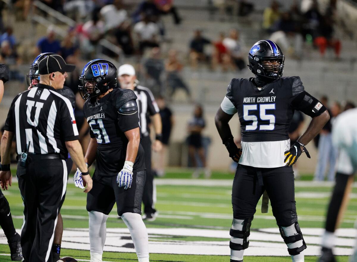 North Crowley offensive lineman Henry Fenuku (55) looks to the sidelines for the call as center John Delgado (51) prepares to snap the ball during a UIL football game at Crowley ISD Sports Complex in Fort Worth Friday, Sept. 13, 2024.