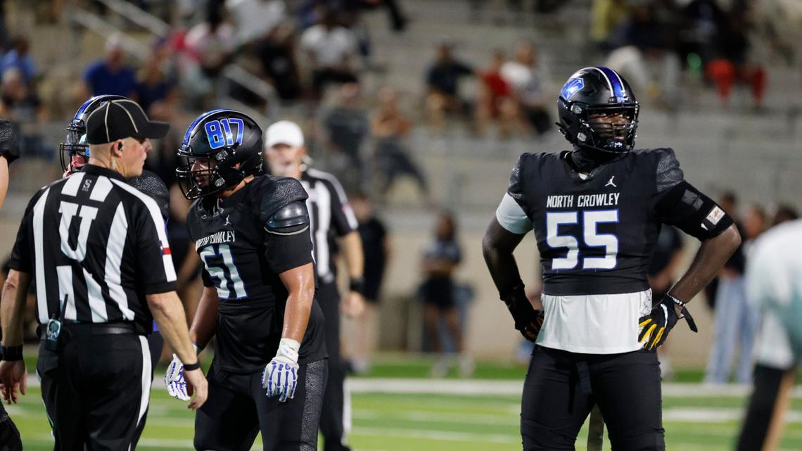 North Crowley offensive lineman Henry Fenuku (55) looks to the sidelines for the call as center John Delgado (51) prepares to snap the ball during a UIL football game at Crowley ISD Sports Complex in Fort Worth Friday, Sept. 13, 2024.