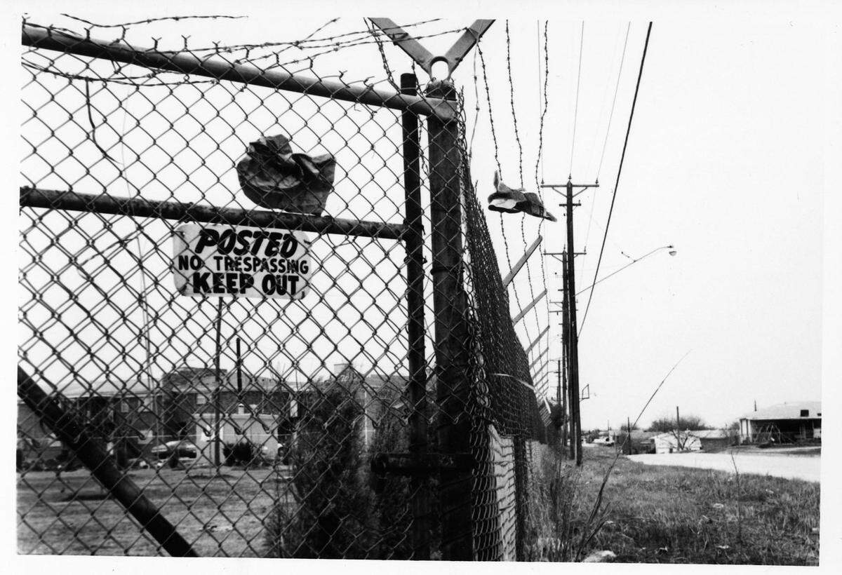 A sign stating “Posted No Trespassing Keep Out” placed on the Como side of the fence part of the “Ridglea Wall.”
