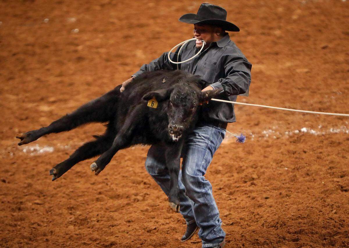 Paco Akins of Fort Worth competes in tie-down roping during the Cowboys of Color Rodeo in 2020. The sport can be a dangerous one.