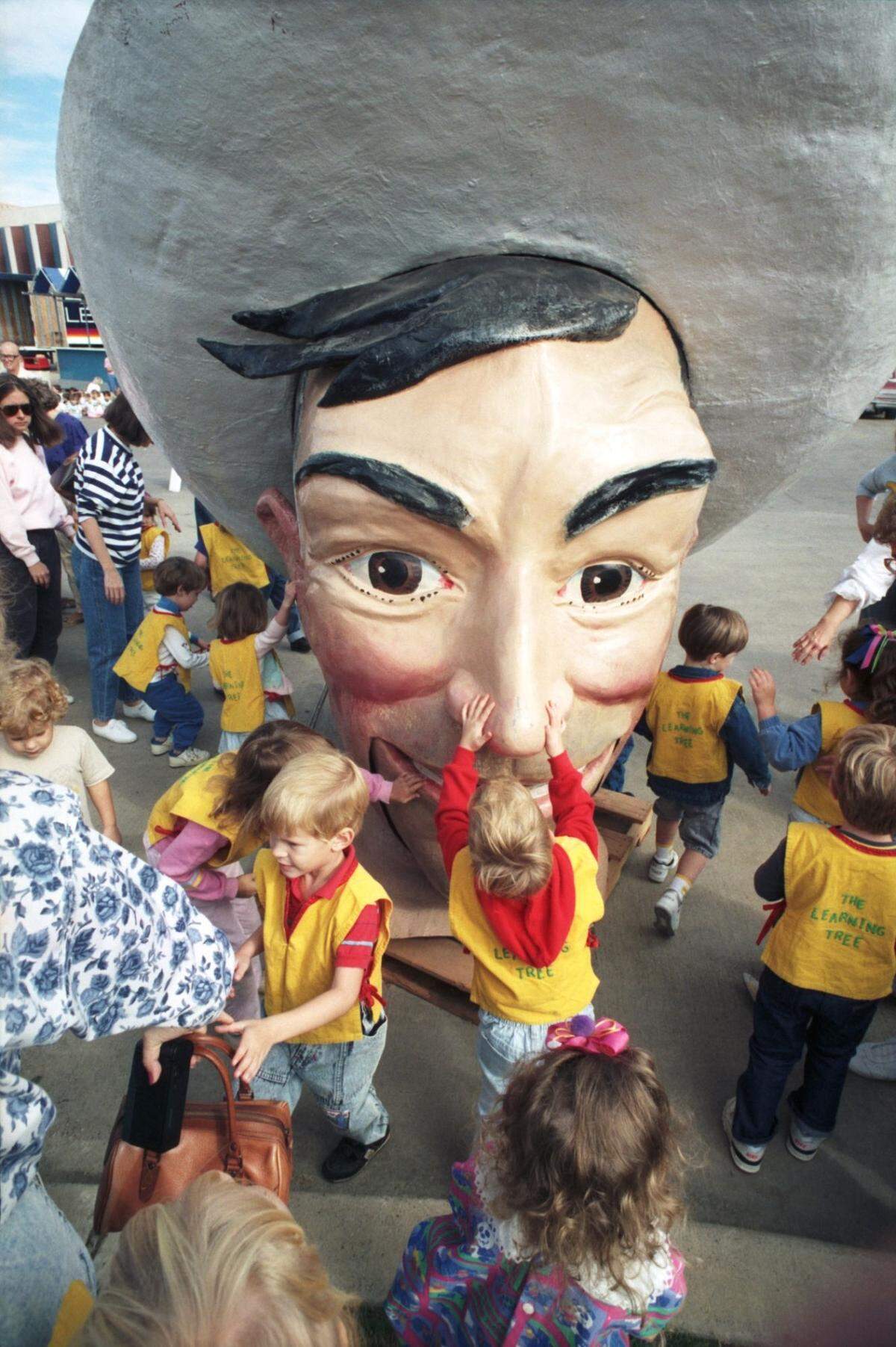 Sept. 25, 1990: Dallas preschoolers come face to face with Big Tex, the 52-foot-tall mascot of the State Fair of Texas, before his head is raised and assembled onto his shoulders at Fair Park in Dallas.
