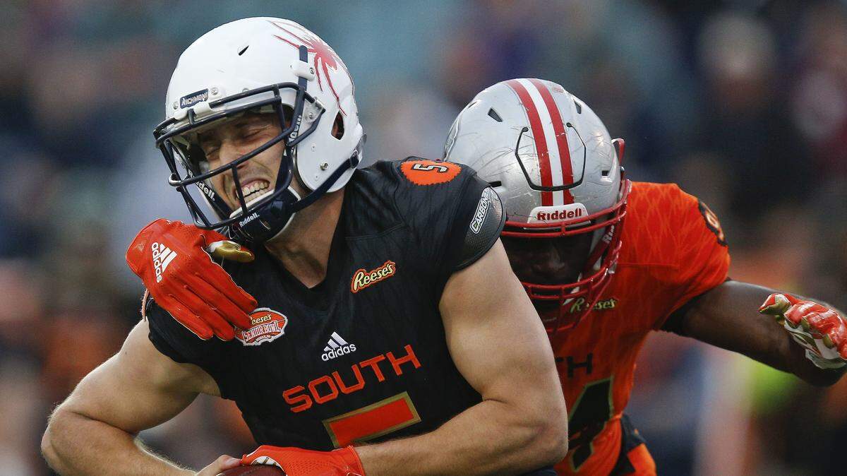 Kyle Lauletta, of Richmond, avoids a sack during the second half of the Senior Bowl NCAA college football game in Mobile, Ala., Saturday, Jan. 27, 2018. Lauletta threw three second-half touchdown passes to lead the South team to a 45-16 victory.