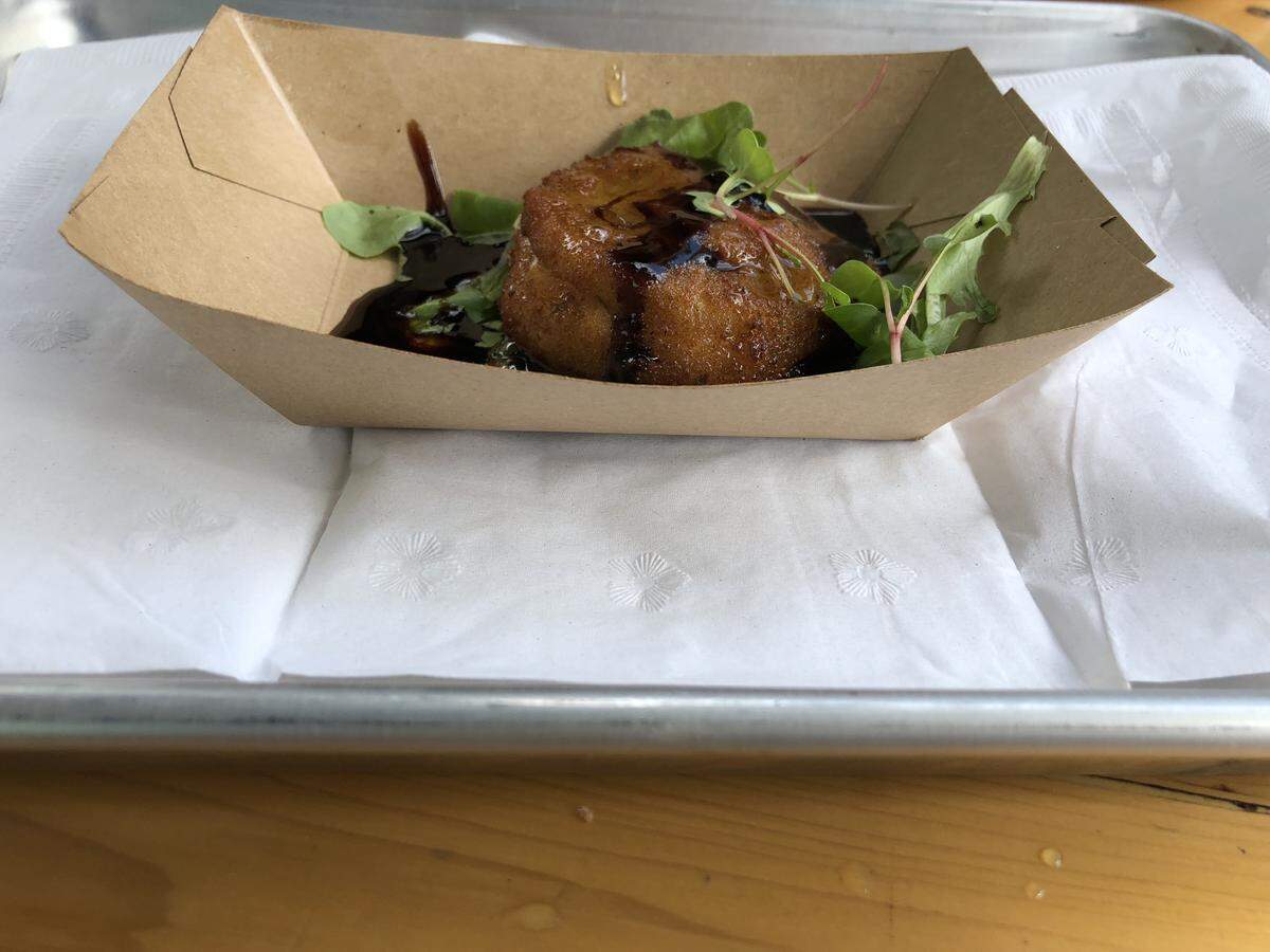 Fried Texas Hill Country is green tomatoes, mozzarella and basil, stacked and then covered in breadcrumbs and fried into a disc-shaped fritter.