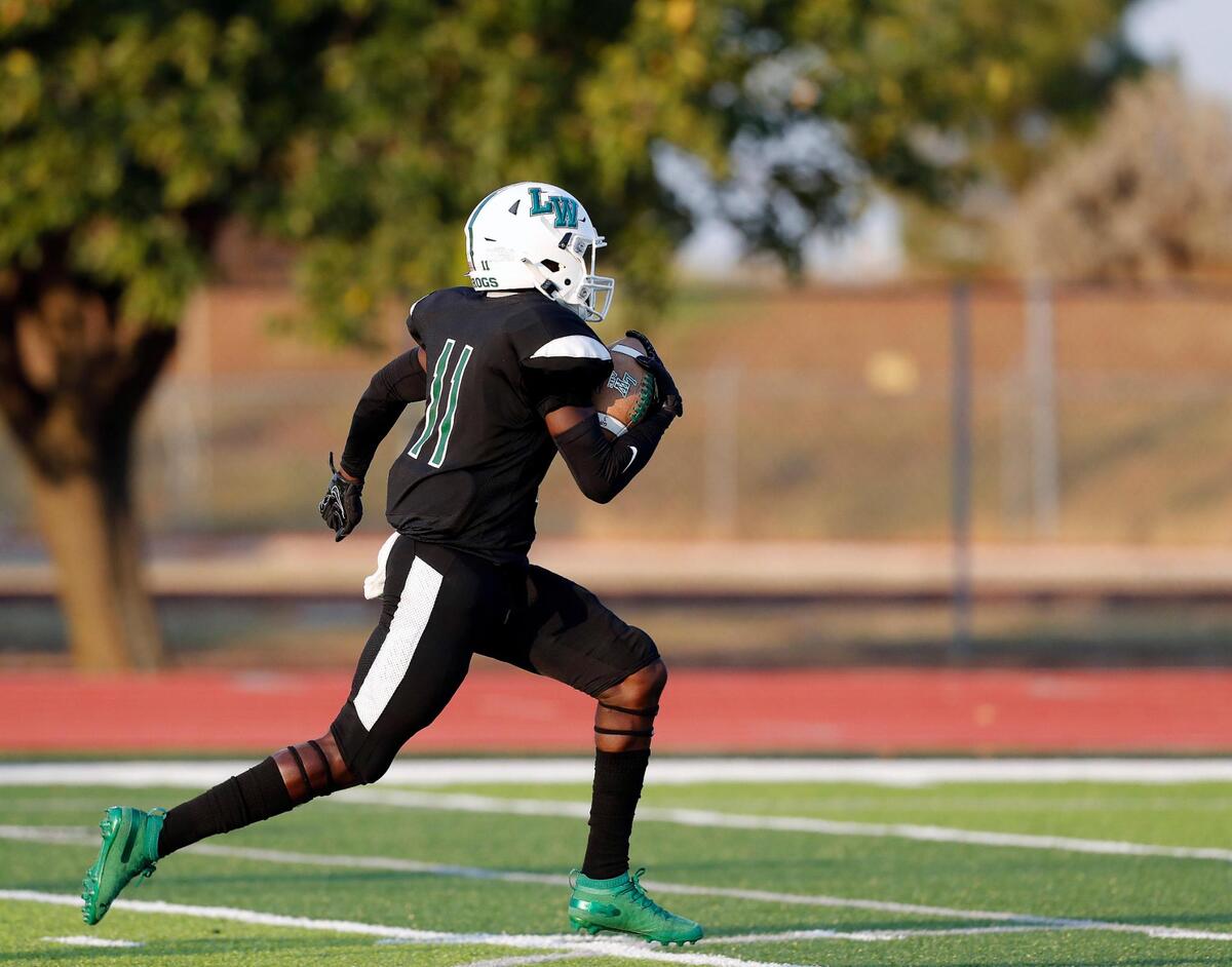 Lake Worth wide receiver Damirion Polty (11) sprints down the field alone for the games first points during a high school football game at Kittrell Memorial Stadium in Lake Worth, Friday Aug. 28, 2020. Lake Worth defeated McGregor 47-43 to start the season. Temperatures were 111 at the start the game and 94 when it ended. (Special to the Star-Telegram Bob Booth)