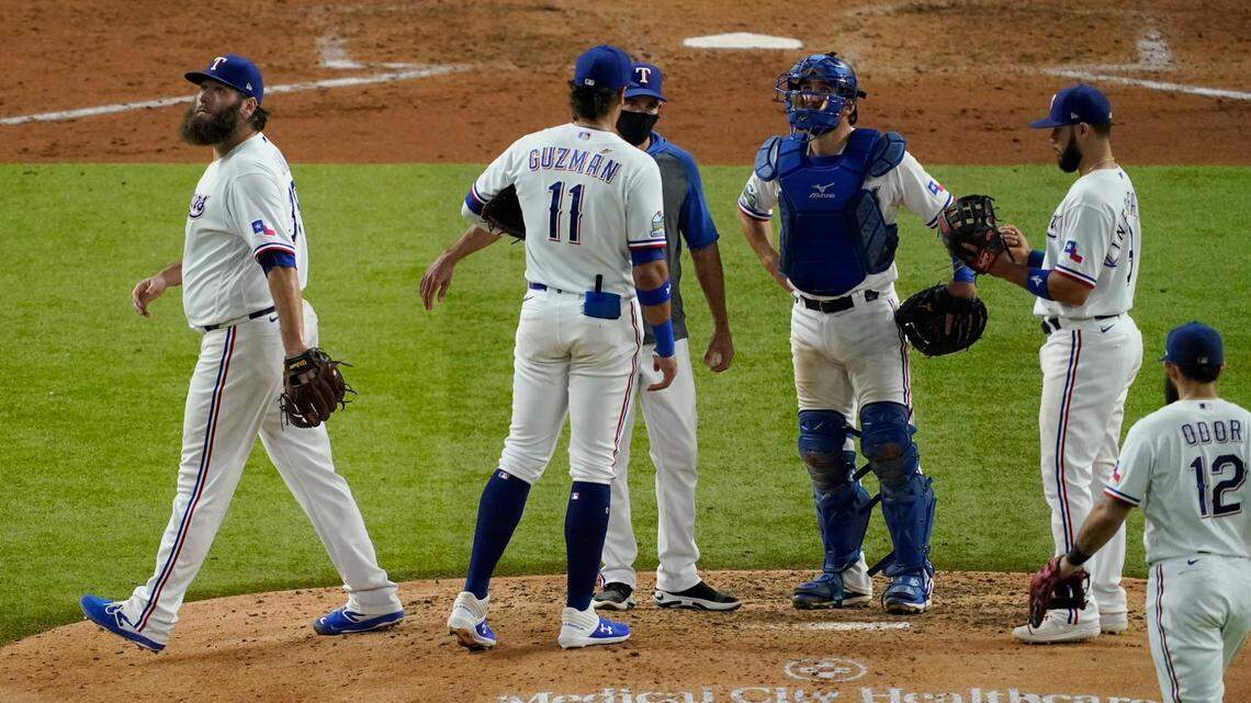 Texas Rangers starting pitcher Lance Lynn, left, is taken out of the game in the sixth inning of Thursday’s 12-4 loss to the Houston Astros in Arlington.