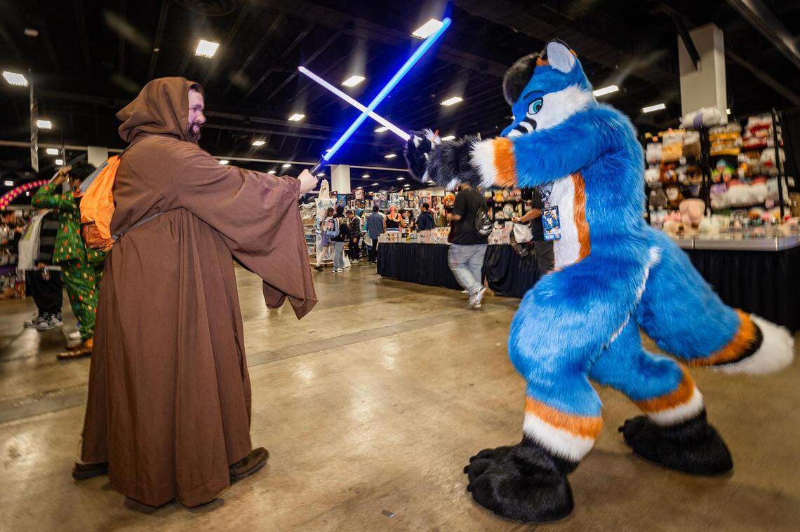 Jake Calangelo, who is dressed as a Jedi Knight, gets in a lightsaber battle with Christopher Walsh, who is dressed as Zulu Fox, for the Anime Frontier event at the Fort Worth Convention Center on Friday, Dec. 8, 2023.