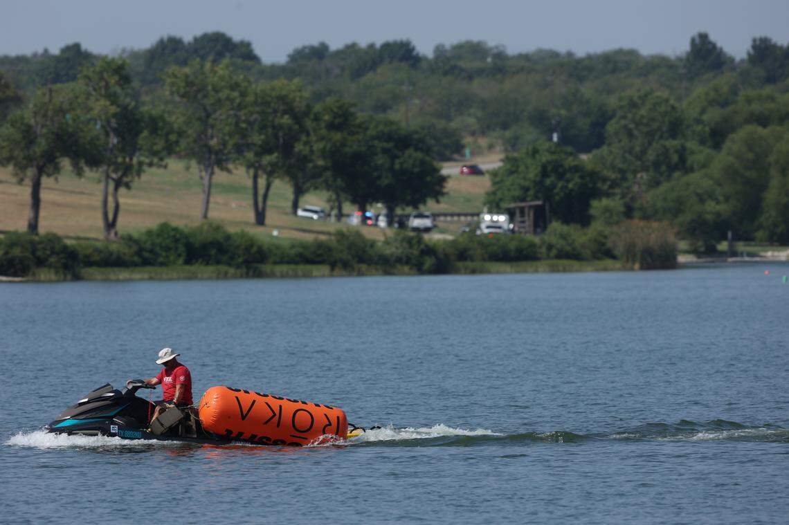 A jet ski pulls in buoys from the CrossFit Games at Marine Creek Lake in Fort Worth on Thursday morning. The Fort Worth Fire Department responded to a call earlier in the morning when athlete Lazar Đukić drowned in the lake, where a swimming event for the CrossFit Games was being held.