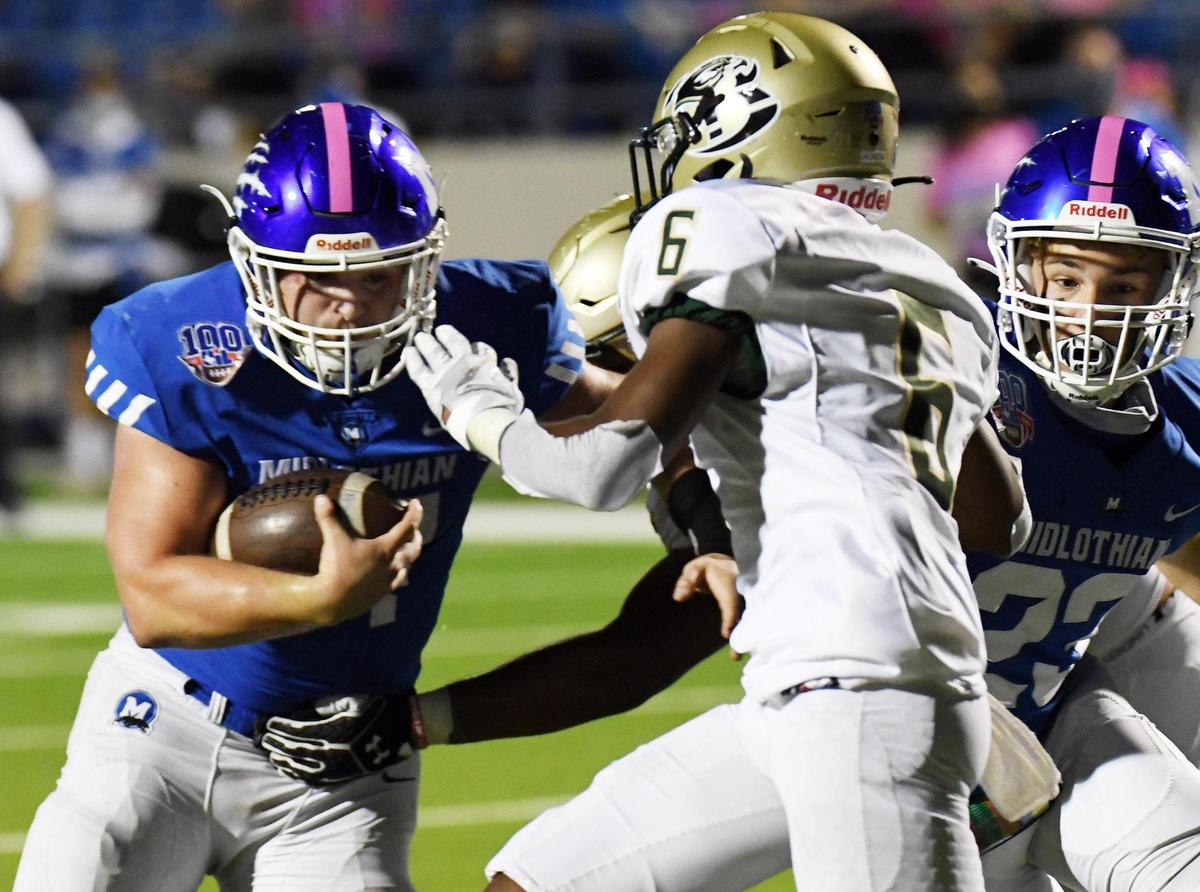 Midlothian’s Ethan Hill, left takes the ball five yards through Birdville’s Jordan Jackson for the touchdown to take a 14-0 lead in the second quarter of their Division 1 District 4-5A football game Thursday, October 22, 2020 at the Midlothian Multi-Purpose Stadium in Midlothian, Texas. Special/Bob Haynes