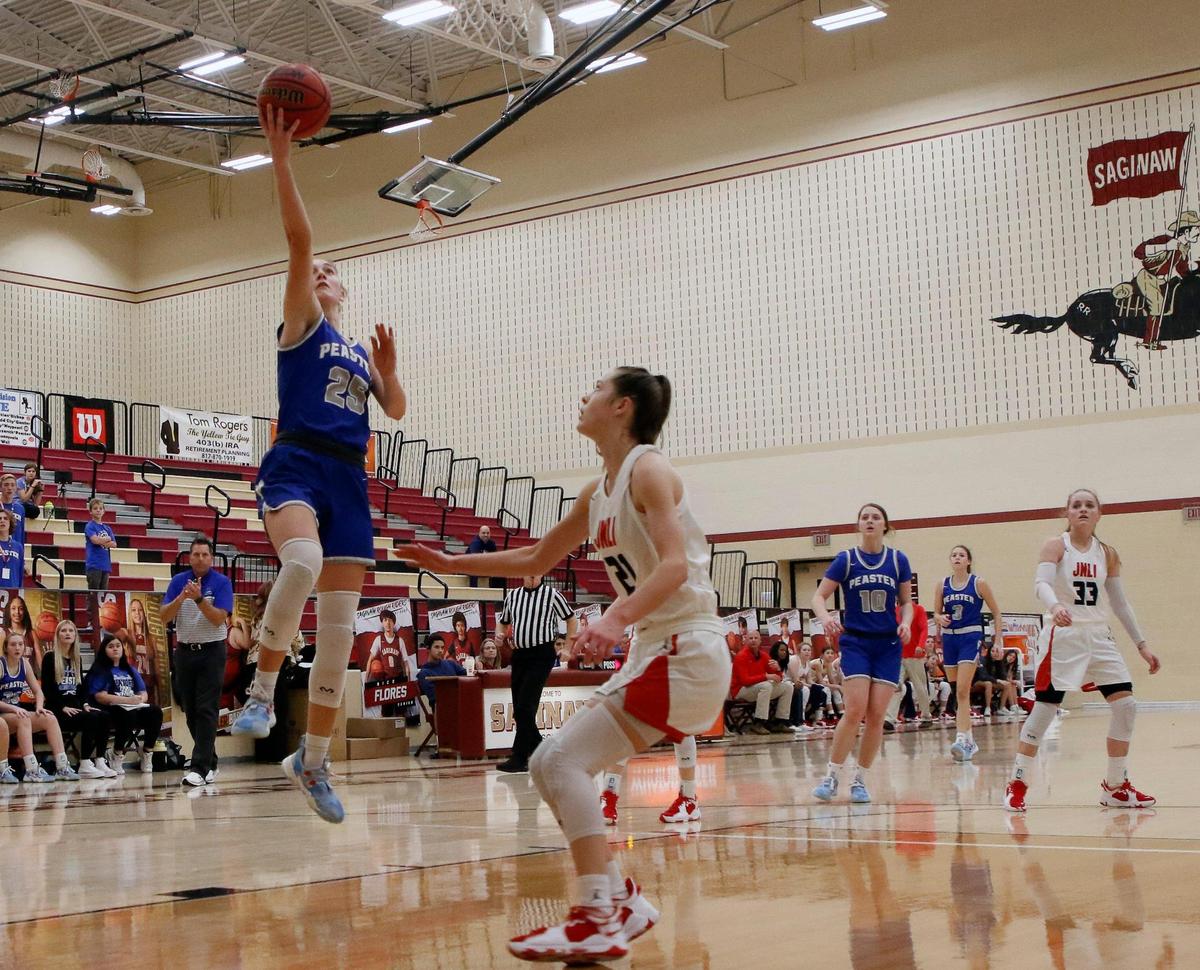Peaster guard Payton Hull (25) puts one in over Jim Ned guard Riley Grohman (21) during a championship game of the Whataburger Basketball Tournament at Saginaw High School in Saginaw, Texas, Thursday, Dec. 30, 2021. Peaster defeated Jim Ned 64-48. (Special to the Star-Telegram Bob Booth)