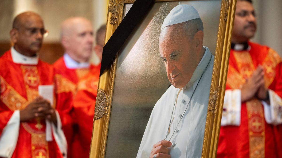A photo of Pope Francis is displayed during an official diocesan memorial Mass for Pope Francis at Cathedral of the Incarnation in Nashville, Tenn., Monday, April 28, 2025.