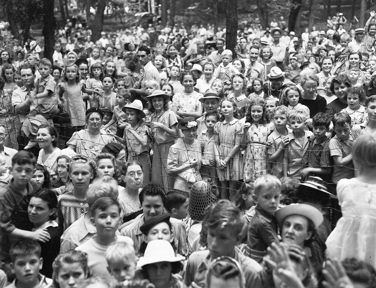 A large crowd of families with children, most of them facing the camera.